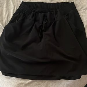 black no pleaded skort with zip pockets It is a large and is from all in motion